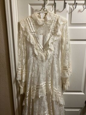 Vintage-Inspired Cream Lace Wedding Dress with High Neck Ruffle